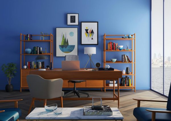 Elegantly decorated home office with modern furniture and a blue wall.
